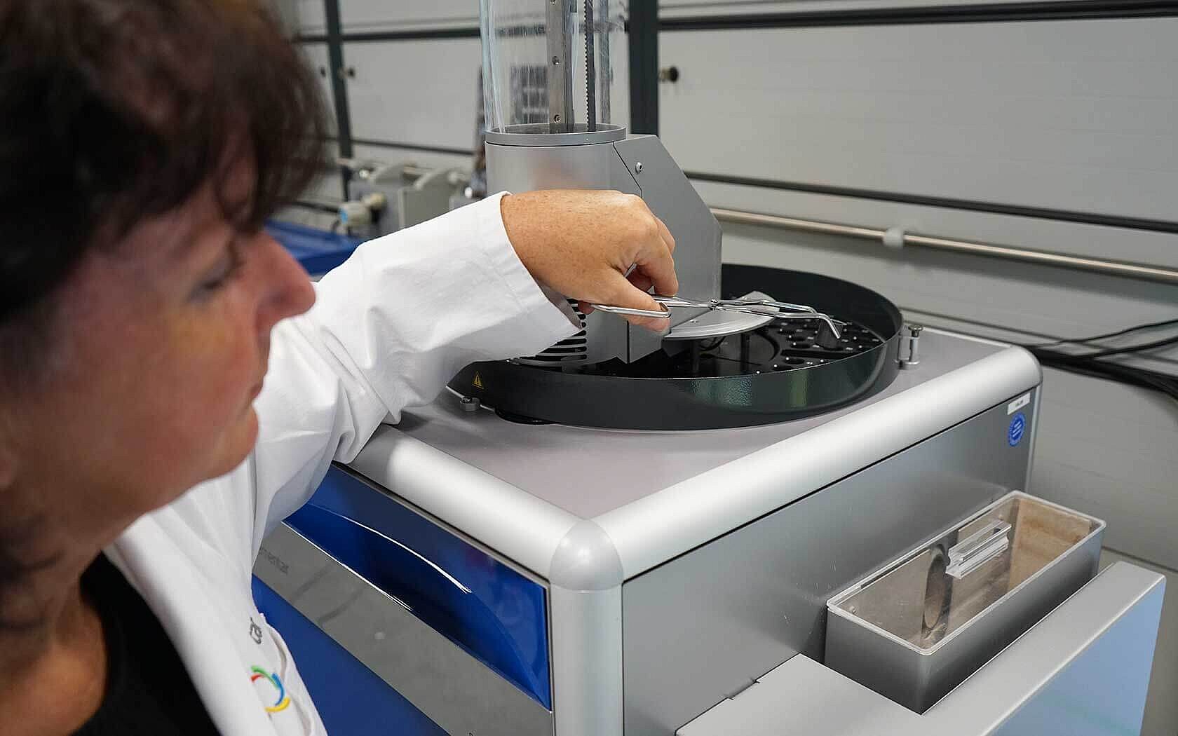 Woman placing samples on a TOC analyzer