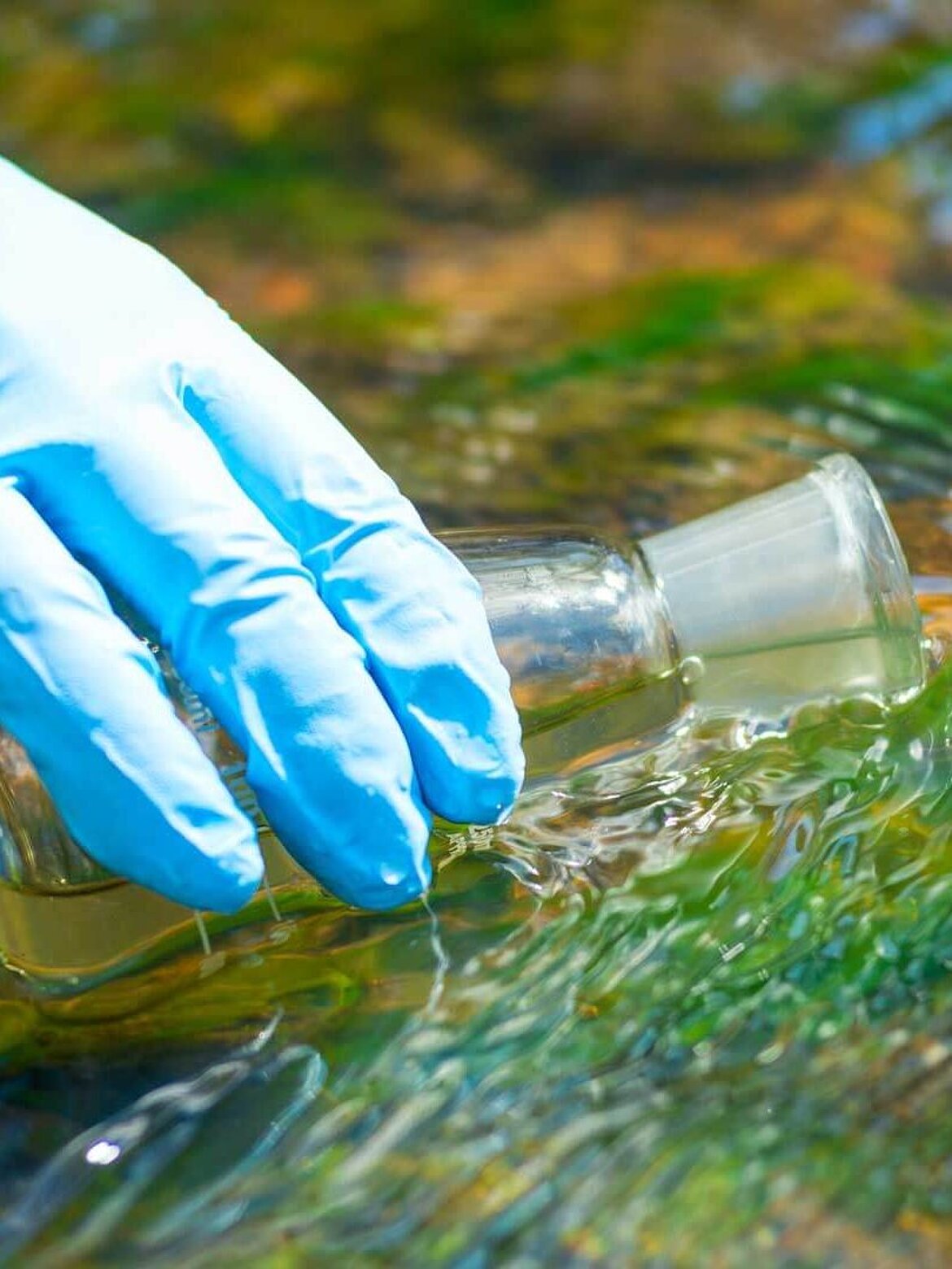 Drawing water into a research flask from a stream