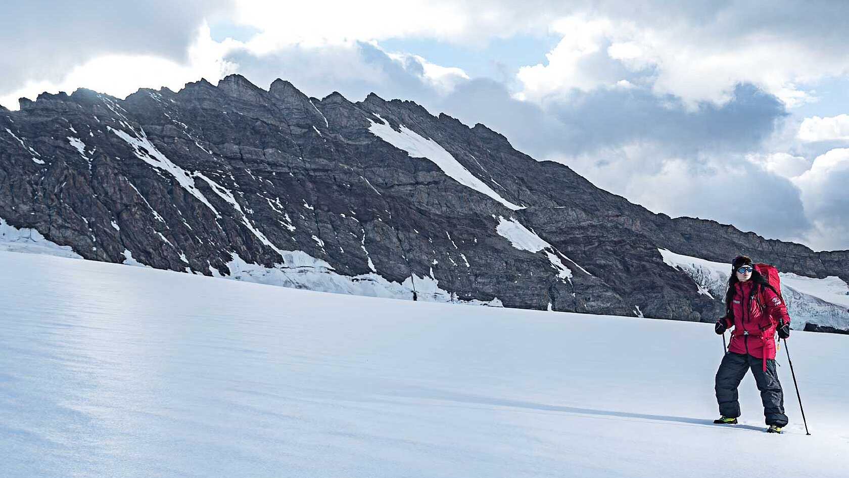 Hiker in snowy mountain landscape