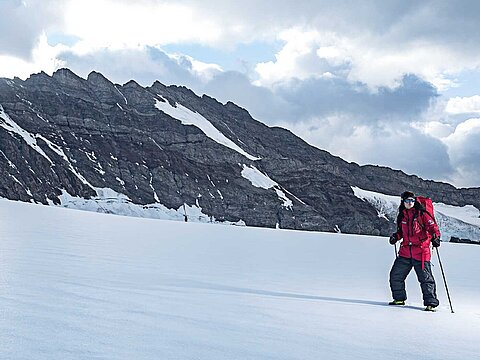 Hiker in snowy mountain landscape